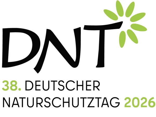 Logo für den Deutschen Naturschutztag 2026; die Buchstaben D, N und T in schwarz, wobei aus dem T kreisförmig Blätter ragen, sodass es wie ein stilisierter Baum aussieht